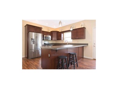 VIEW OF SPACIOUS KITCHEN W/ BREAKFAST BAR...