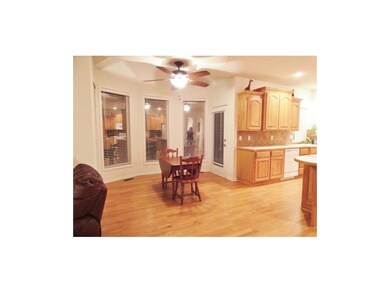 EAT IN KITCHEN SPACE WITH BOW-BAY AND CEILING FAN.