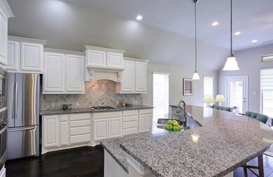 Stunning! Inviting! Welcoming! Awesome back-splash enhances granite! White raised panel cabinets with drawers and drawers! Side by Side stainless refrigerator! Pendulum lighting! Semi-circle island for visiting or eating! Prepare? Serve? Enjoy!!