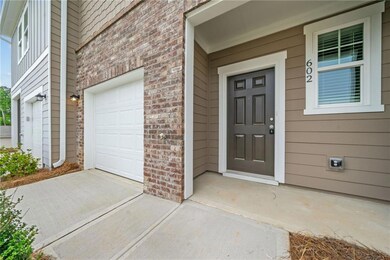 View of exterior entry with brick siding