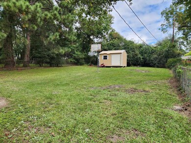 View of yard featuring a storage unit