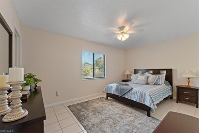 Bedroom with a ceiling fan, baseboards, and light 