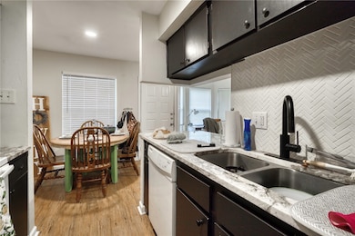 Kitchen with white dishwasher, a sink, decorative