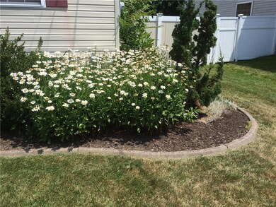 Nice landscaping wraps around the house and garage