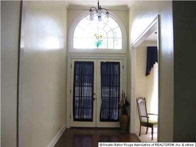 Welcoming foyer with fresh paint and hardwood floo