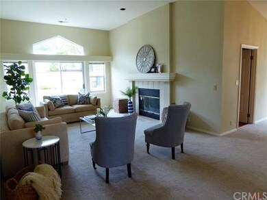 Living room with fireplace, high ceilings and acce