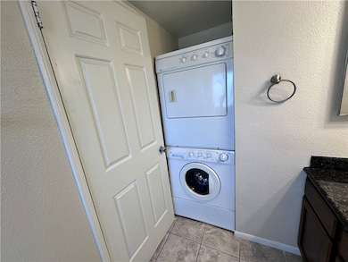 Laundry room featuring stacked washer / drying mac