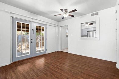Empty room with dark wood-type flooring, french d