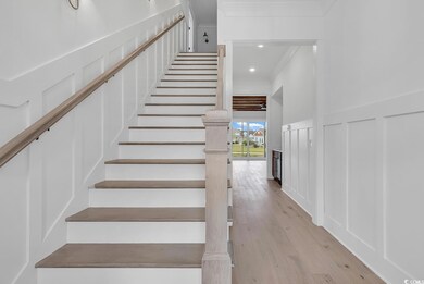 Stairway with hardwood / wood-style flooring and c