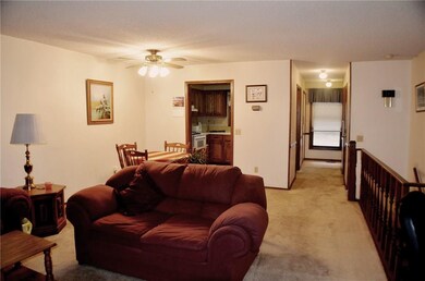 From the Living Room looking towards the Dining area and kitchen. The entry area is down the short hall on the right. There is also a half bath across from the Kitchen.