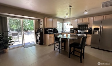 Kitchen has a sliding glass door that opens to a expansive sundeck that offers BBQ/dining, lounging and hot tub areas.