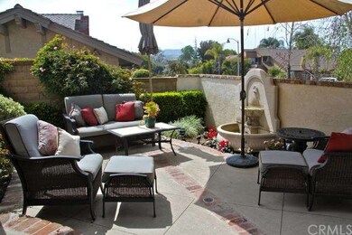 Entry courtyard patio with a fountain and brick ac