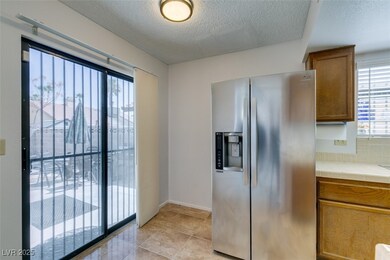 Kitchen with stainless steel refrigerator with ice