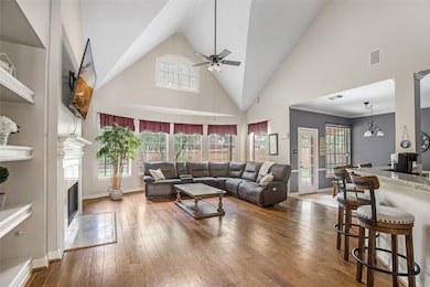 Grand living area with high ceilings, hardwood flo