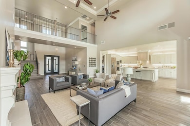 Experience the spacious Great Room with a premium surround sound system and an impressive soaring ceiling accented by elegant crown moulding.