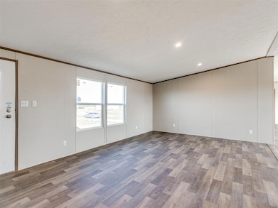 Unfurnished room featuring ornamental molding, light wood-style flooring, a textured ceiling, recessed lighting, and a decorative wall