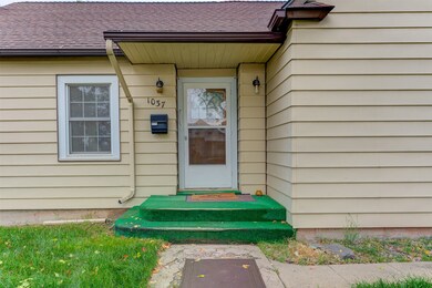 View of exterior entry featuring roof with shingles
