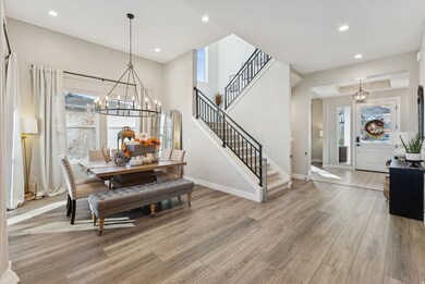 Dining space featuring a chandelier, recessed lighting, stairs, and light wood-type flooring