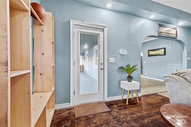 Glass front door with integrated blinds allows the morning light to brighten the living room and showcase the hardwood floors.