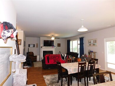 Dining room featuring a fireplace, dark wood finished floors, plenty of natural light, and ceiling fan