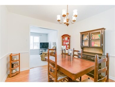 The dining room features hardwood floors and chair rail detail.