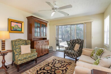 Living room with a textured ceiling, baseboards, d