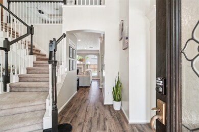 Step inside to a dramatic two-story foyer where na