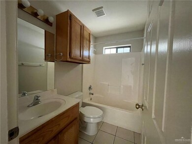 Full bath featuring toilet, tile patterned flooring, vanity, and  shower combination