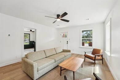 Living area featuring visible vents, baseboards, 
