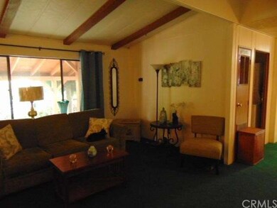 Living Room view to Guest Bath and Kitchen area.