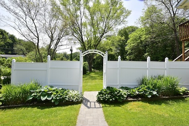 A stylish and low-maintenance vinyl fence provides elegance and privacy.