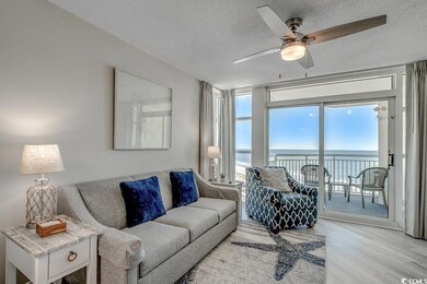 Living room featuring ceiling fan, a textured ceil