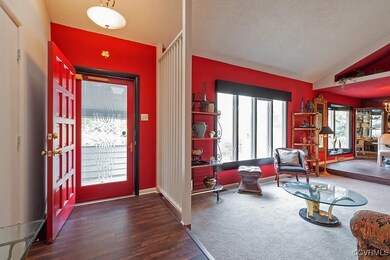 Foyer entrance featuring a textured ceiling, dark