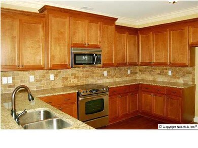 KITCHEN WITH GRANITE COUNTERTOPS AND TILE BACKSPLASH