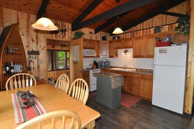 Kitchen has a small island with countertop extensi