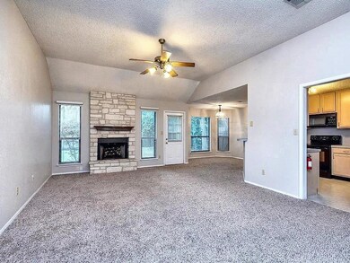 Unfurnished living room featuring lofted ceiling,