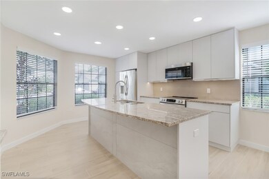 Kitchen with a sink, a center island with sink, wh