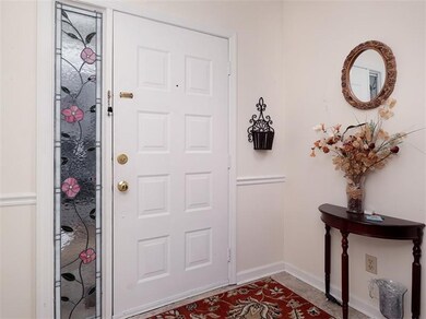 Painted neutral walls and a chair rail in the entr