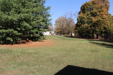 Mature trees in back.