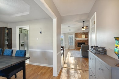 Dining room with a raised ceiling, a textured ceil