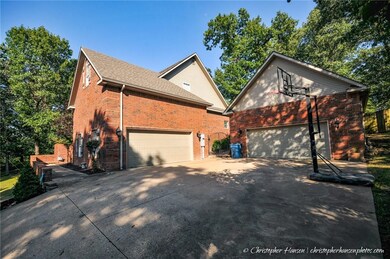 Side garage entry with extra garage/workshop steps away.