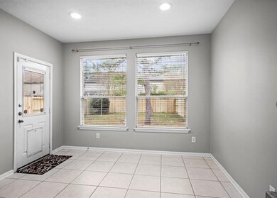 Bright dining area with large windows offering gar