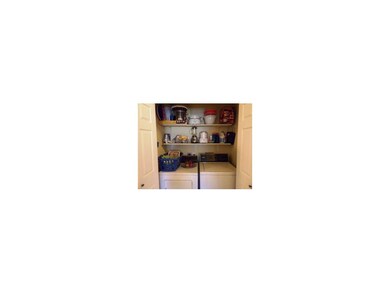 Laundry space behind double doors has additional s