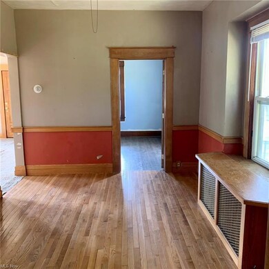 Wood floored spare room with plenty of natural lig