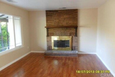Fireplace with brick hearth in living room.