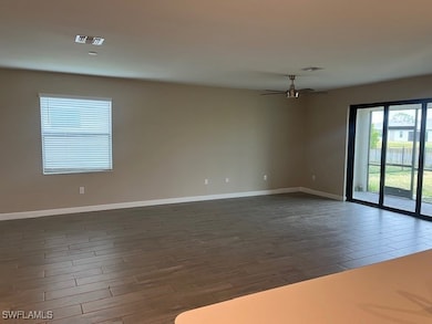 Spare room with ceiling fan and dark hardwood / wo