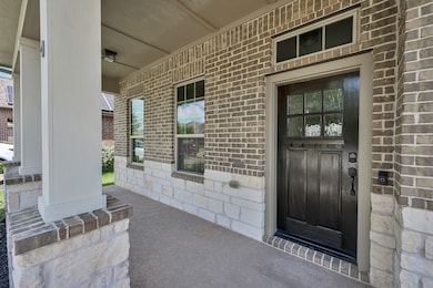 Relax on the inviting covered front porch, perfect