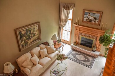 Views of the great room with a fireplace.