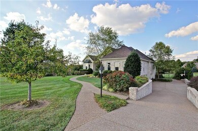 Gorgeous entrance leads to your 4-car garage. Special Note: Garage contains tropical plants that have been stored for the winter as seen below in the backyard photos.  Banana plants also in the 4 garbage cans that will be transplanted this spring.  
