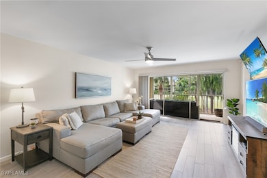 Living area featuring light wood-style tile floors and ceiling fan